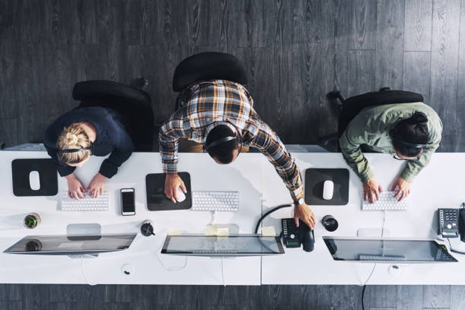 Office staff on desk phones and headsets