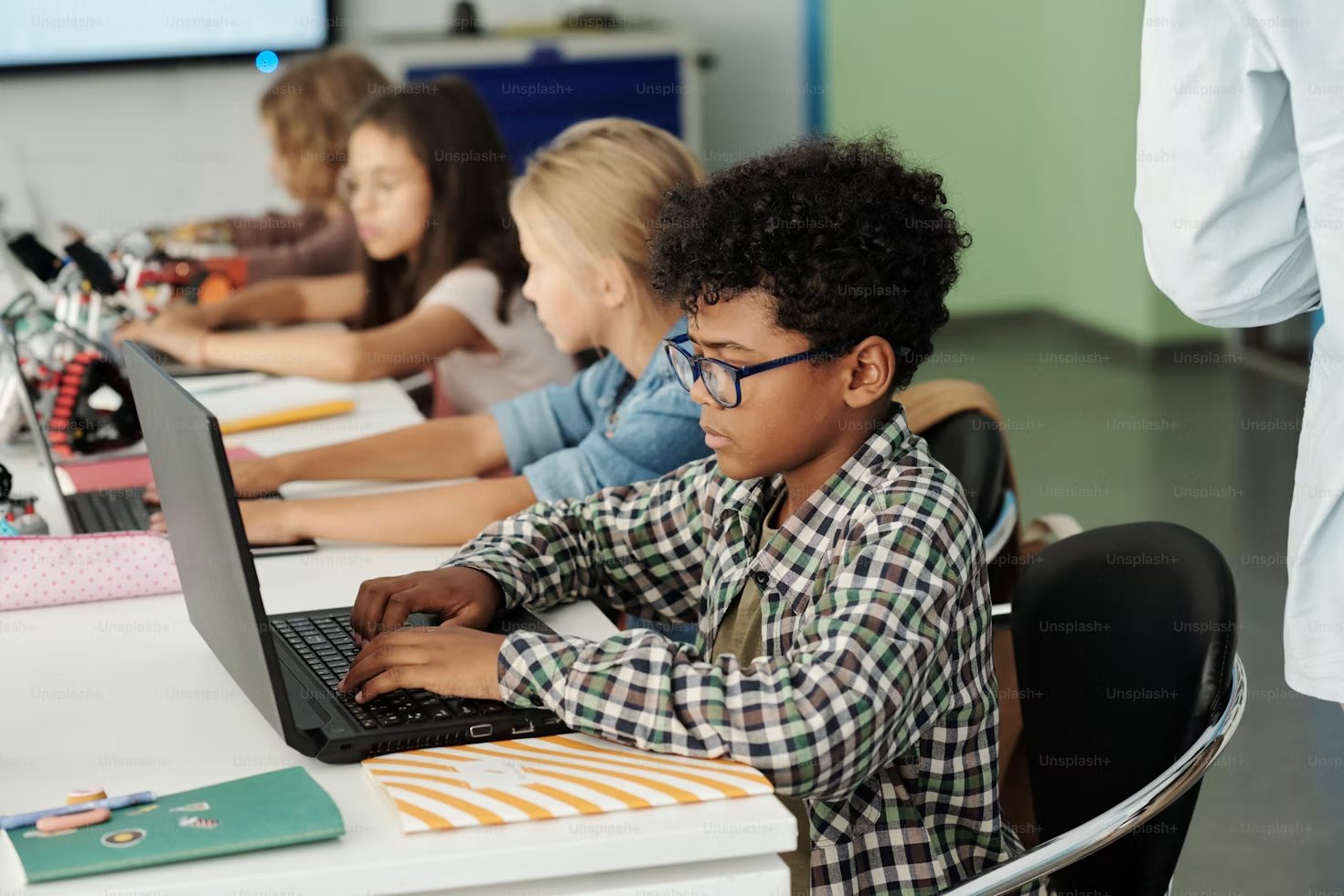 Students working on laptops in a classroom